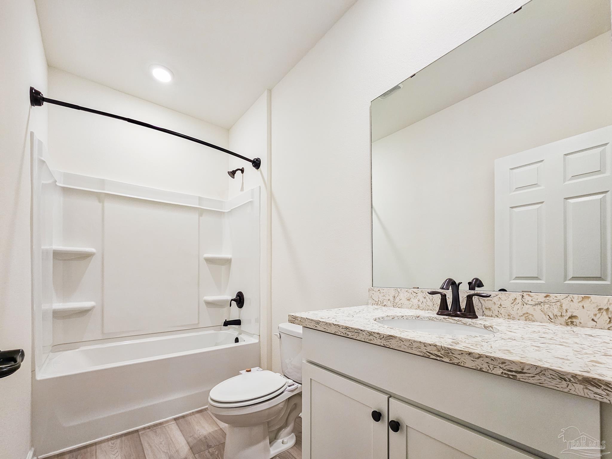 4149 Upper Walk Lane Milton, FL 32583 - Photo 29 of 43 a bathroom with a granite countertop sink a toilet and shower