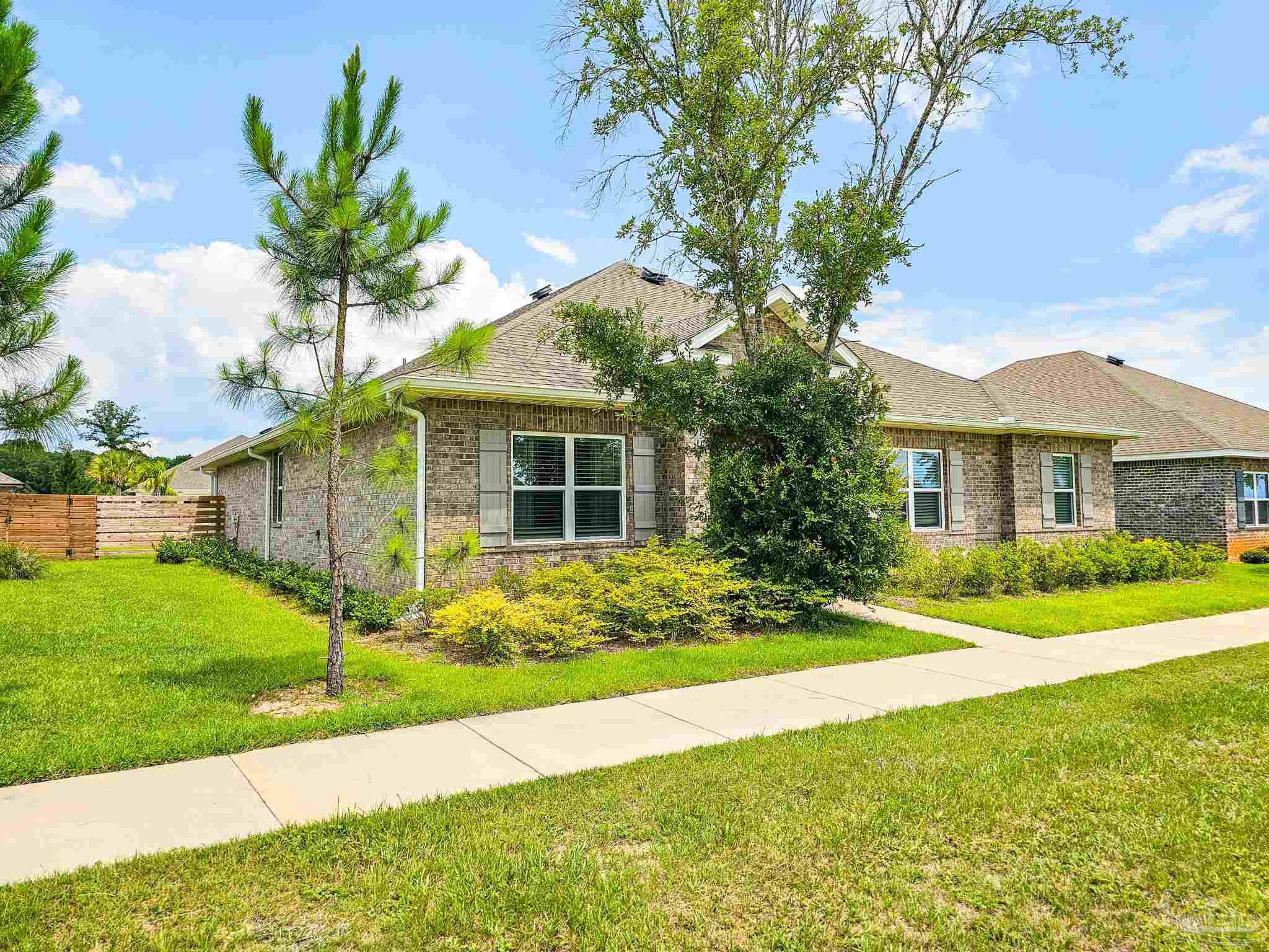 4149 Upper Walk Lane Milton, FL 32583 - Photo 3 of 43 a front view of a house with garden