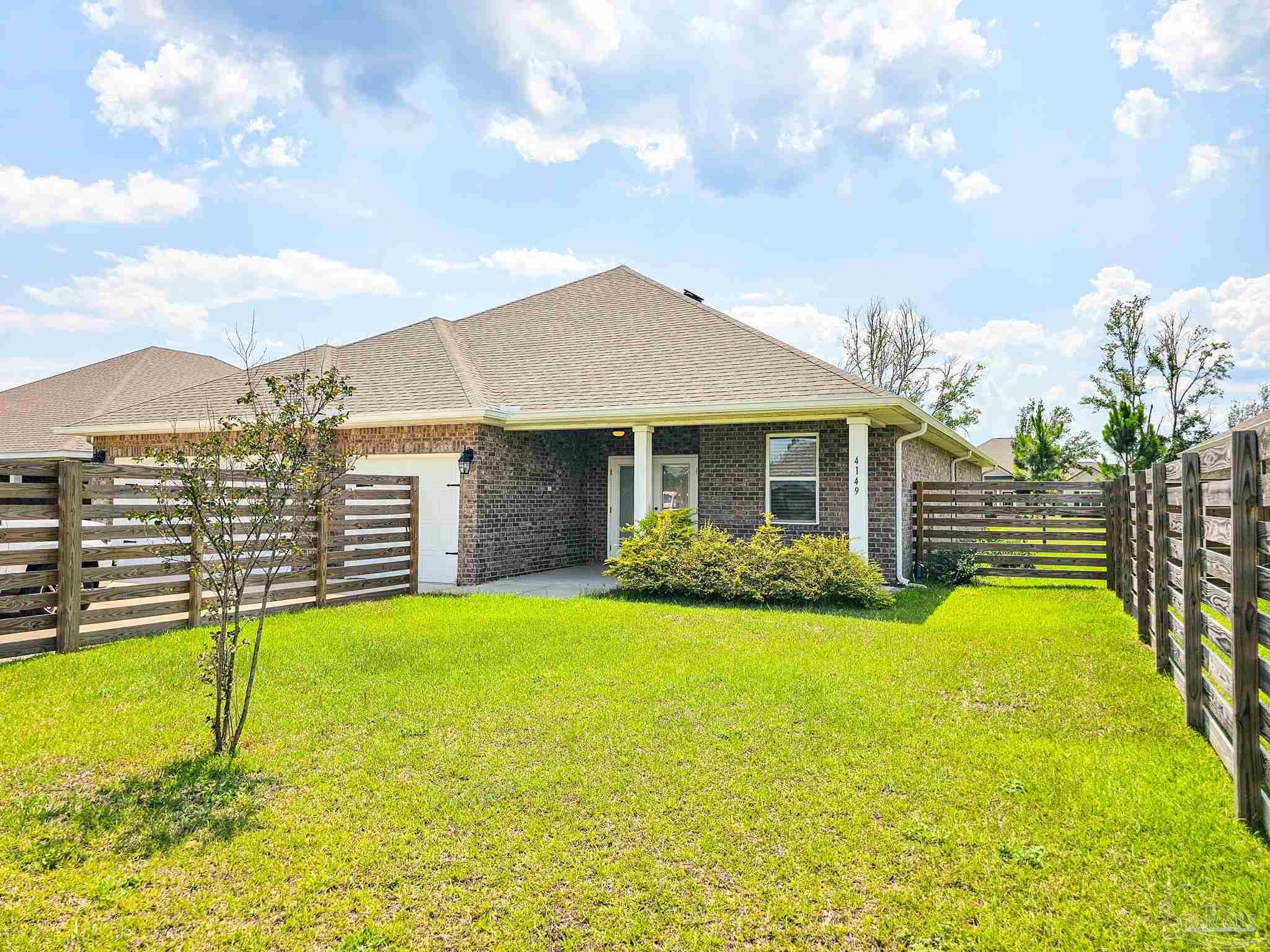 4149 Upper Walk Lane Milton, FL 32583 - Photo 35 of 43 a view of a house with a yard and sitting area