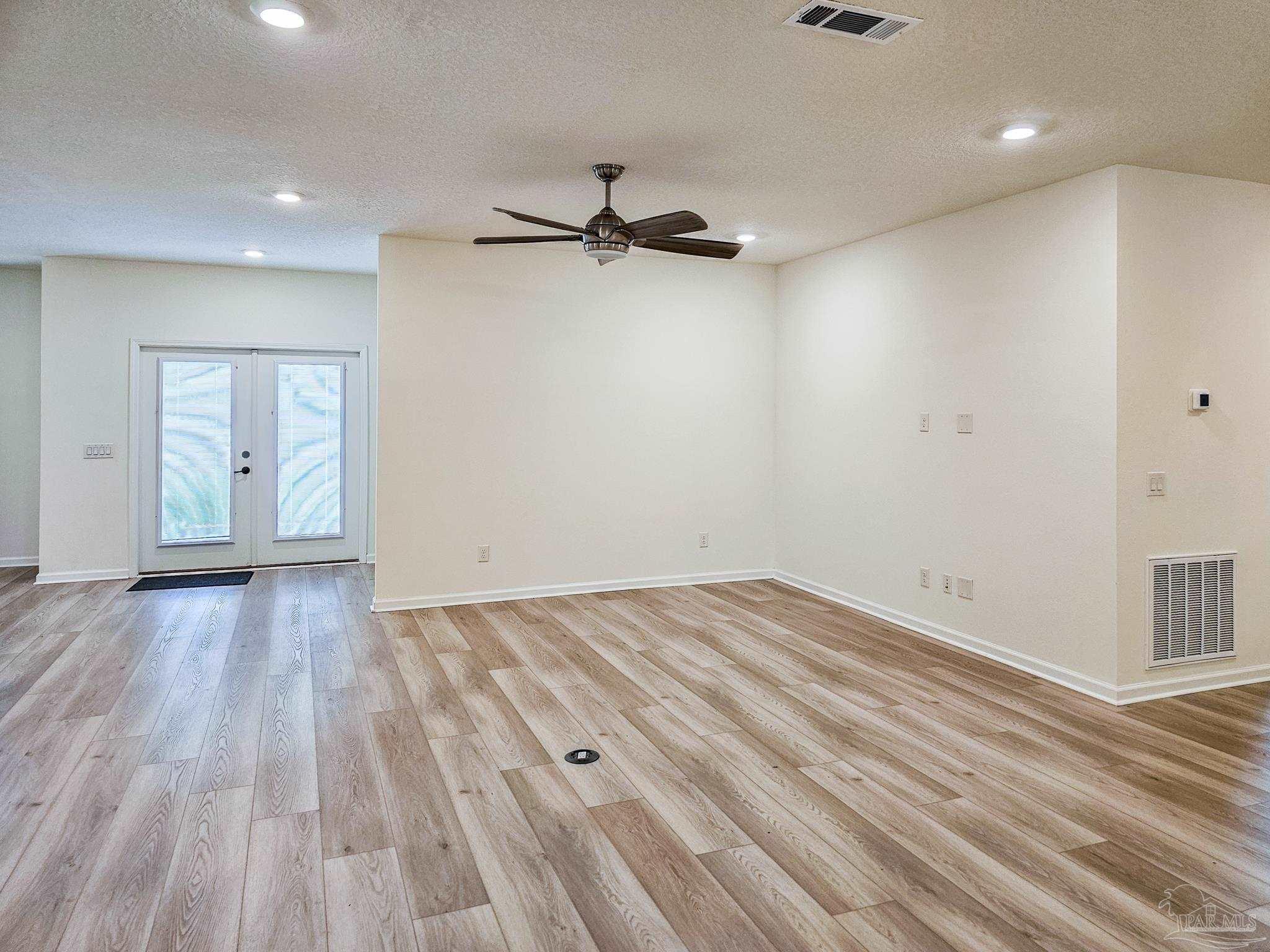 4149 Upper Walk Lane Milton, FL 32583 - Photo 6 of 43 wooden floor in an empty room with a window