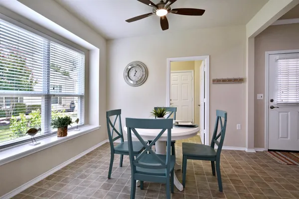 a view of a dining room with furniture and a window