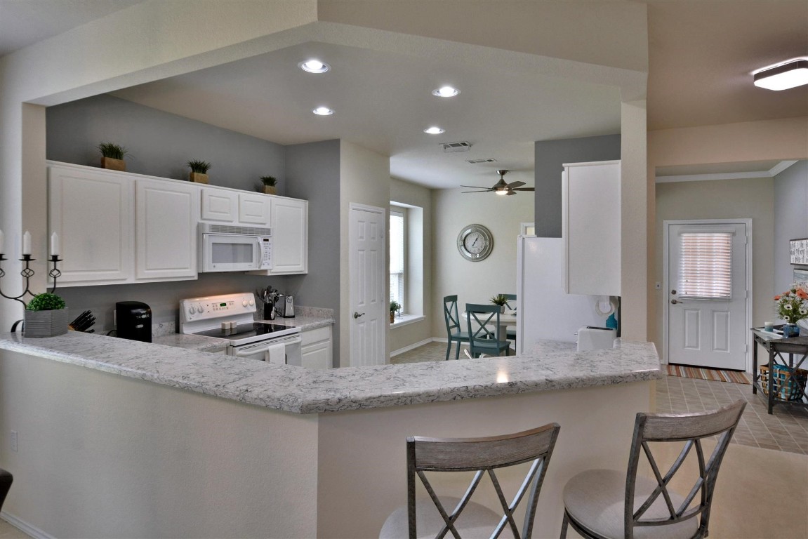 247 Bonham Loop Georgetown, TX 78633 - Photo 19 of 32 a kitchen with stainless steel appliances granite countertop a sink and cabinets