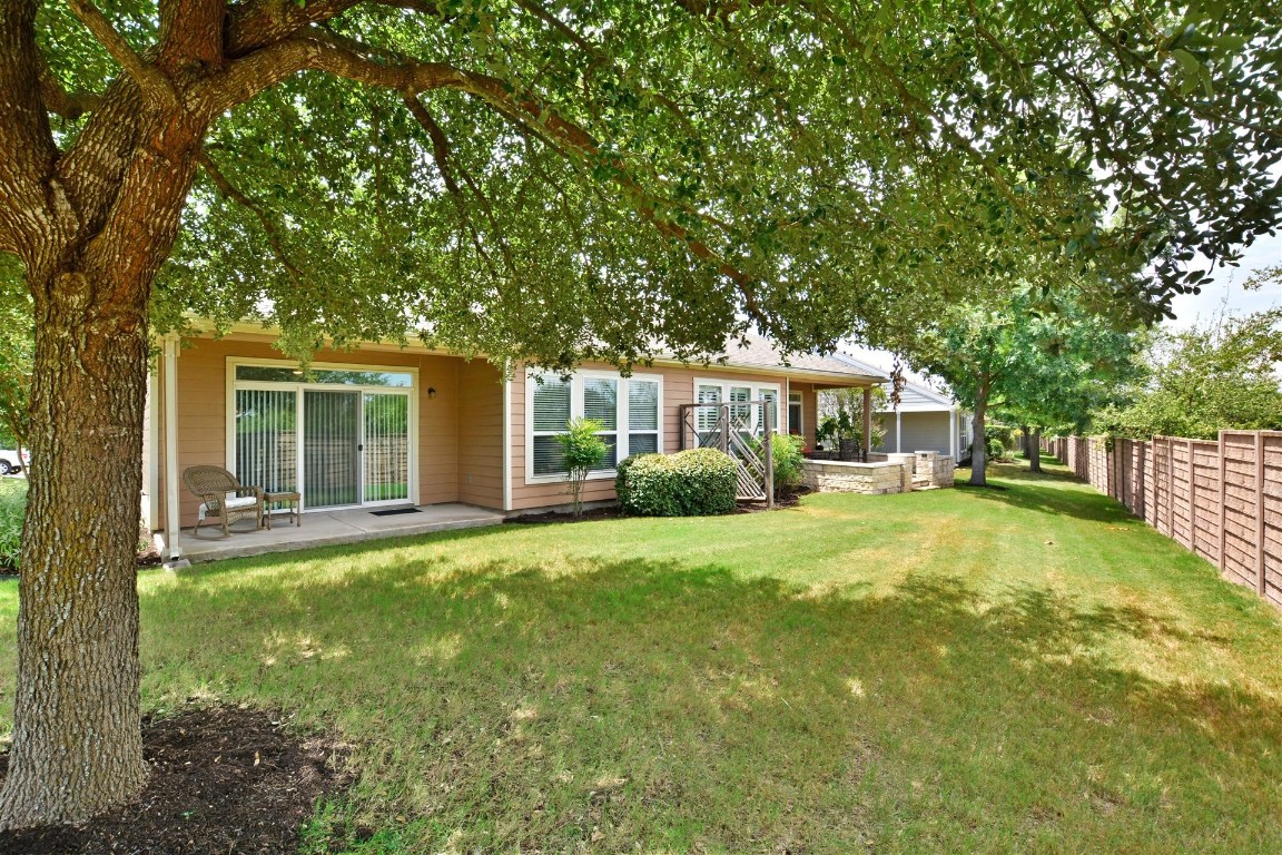 247 Bonham Loop Georgetown, TX 78633 - Photo 22 of 32 a front view of a house with a garden and porch