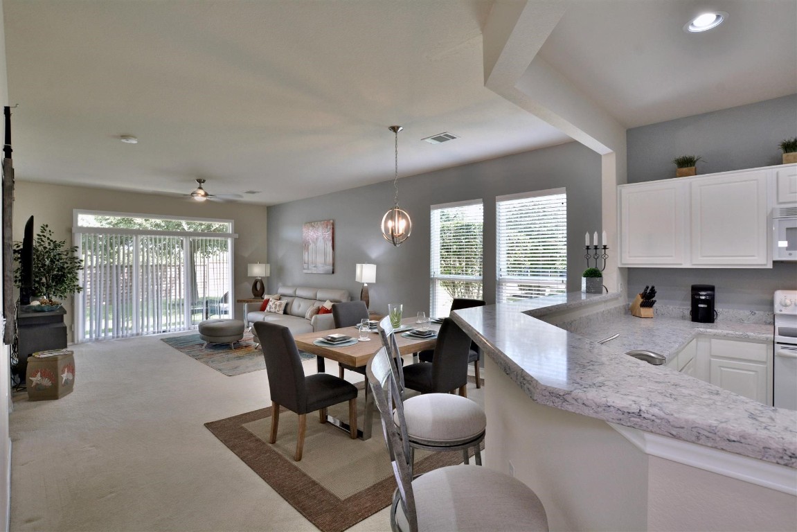 247 Bonham Loop Georgetown, TX 78633 - Photo 3 of 32 a large kitchen with a large window and furniture