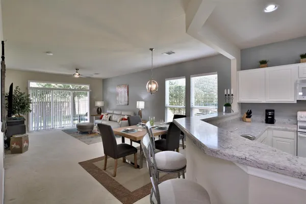 a large kitchen with a large window and furniture