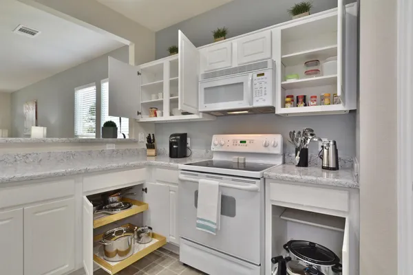 a kitchen with cabinets and window