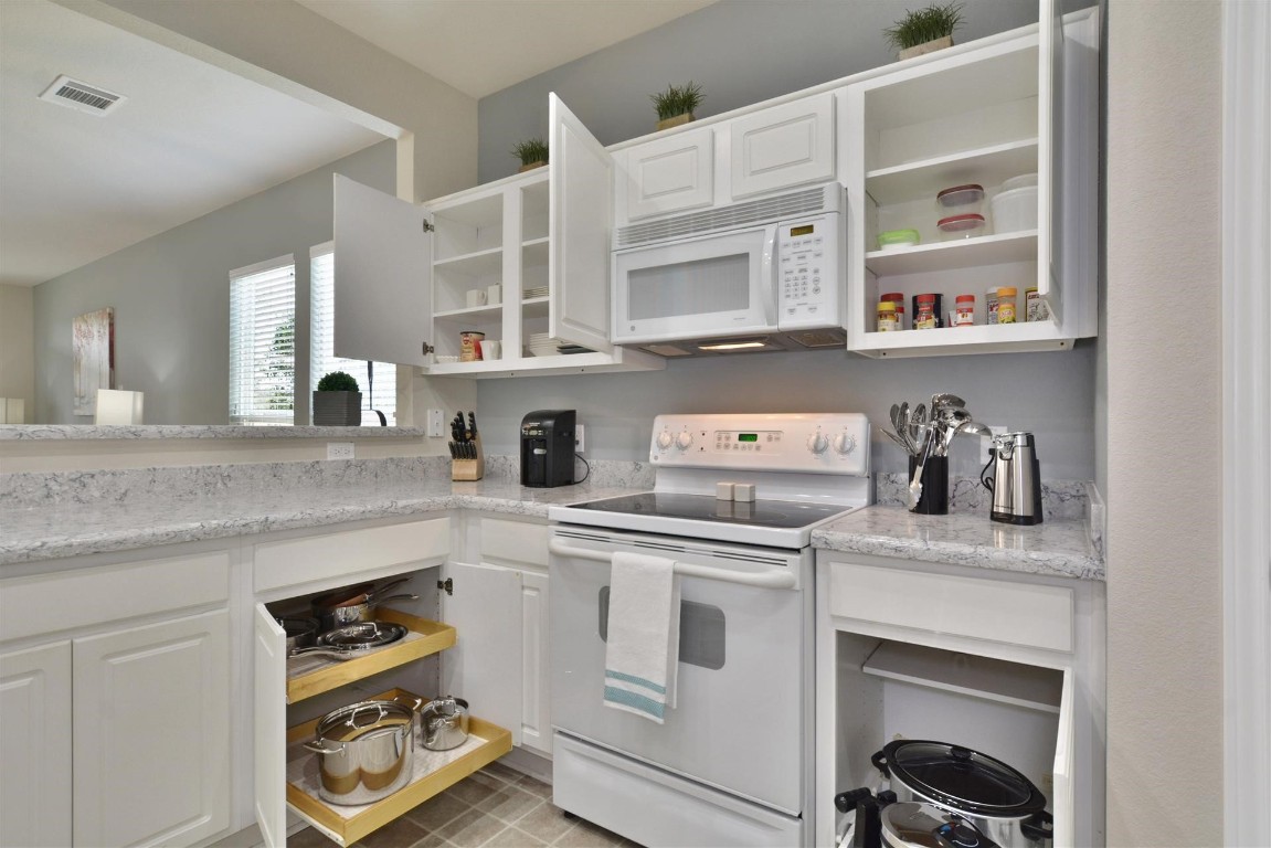 247 Bonham Loop Georgetown, TX 78633 - Photo 8 of 32 a kitchen with cabinets and window