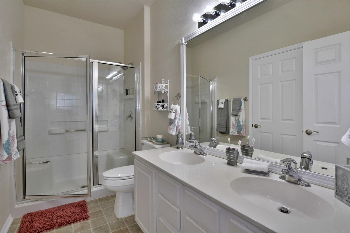 247 Bonham Loop Georgetown, TX 78633 - Photo 9 of 32 a bathroom with a sink toilet and shower