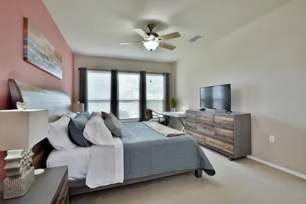 a bed room with a bed and a television