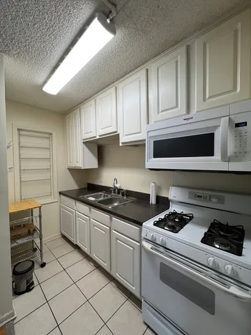 a stove top oven sitting inside of a kitchen