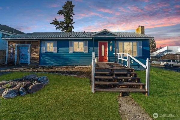 a front view of a house with a garden