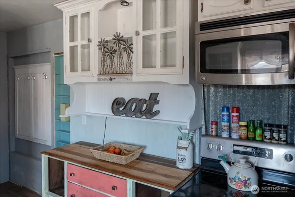 a kitchen with a stove and a microwave