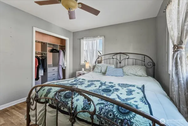 a bedroom with a bed and painting on the wall