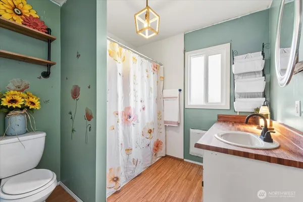 a bathroom with a sink a toilet and shower