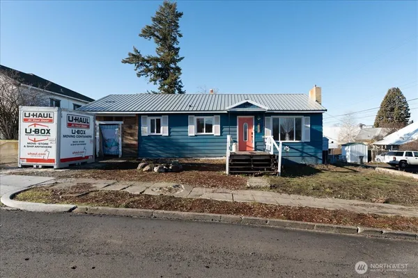 a view of a house with wooden fence