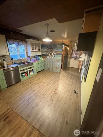 a view of a room with wooden floor