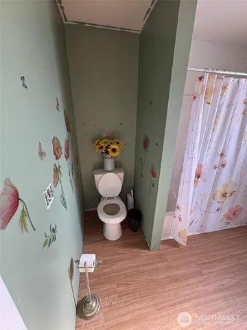 a living room with furniture and a baby crib