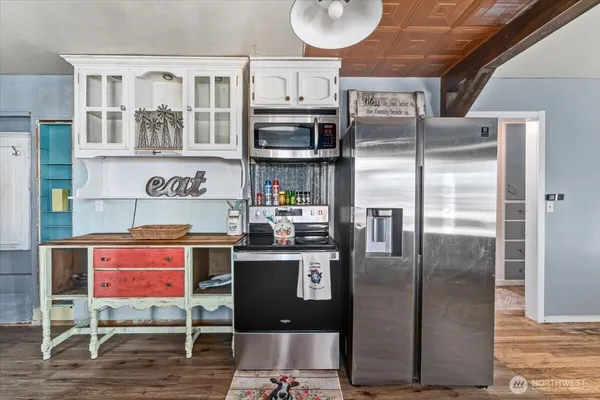 a kitchen with stainless steel appliances granite countertop a refrigerator and a stove