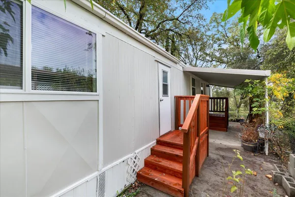 a backyard of a house with seating space and wooden fence