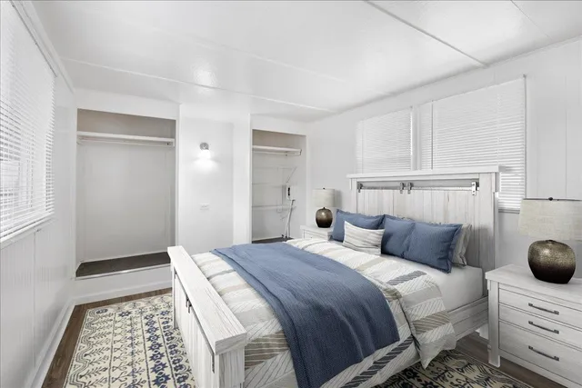 a bedroom with a bed and cabinets