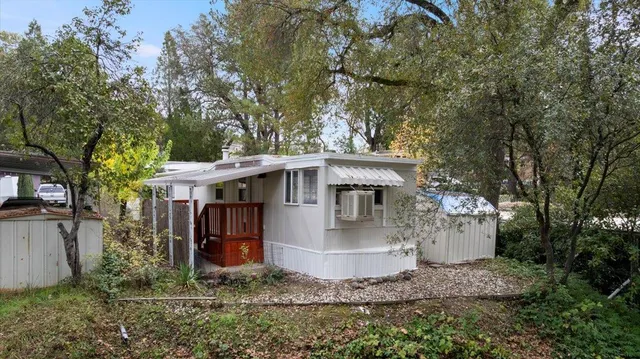 a view of a small house in the middle of a yard