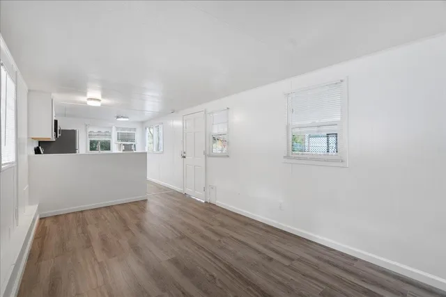 a view of a kitchen with wooden floor and a kitchen