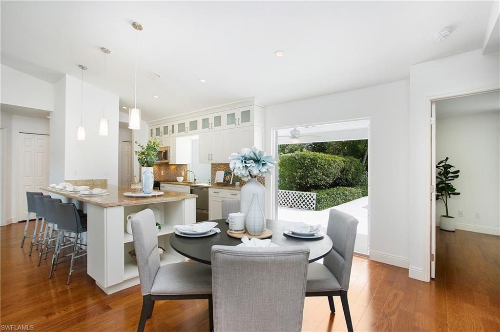 1534 Northgate Drive Naples, FL 34105 - Photo 13 of 50 a dining room with furniture wooden floor and a kitchen