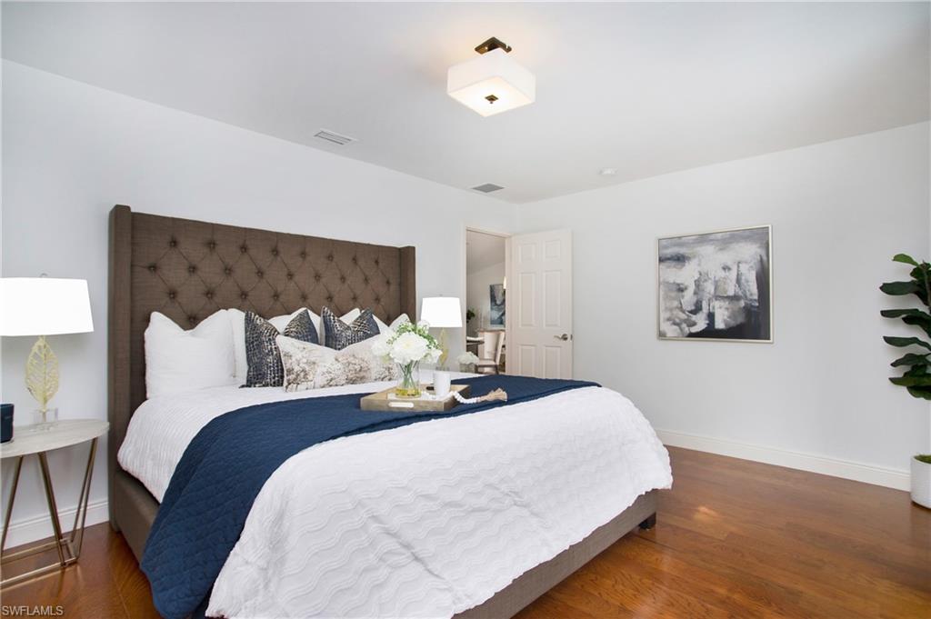 1534 Northgate Drive Naples, FL 34105 - Photo 16 of 50 a bed room with bed and a night lamp