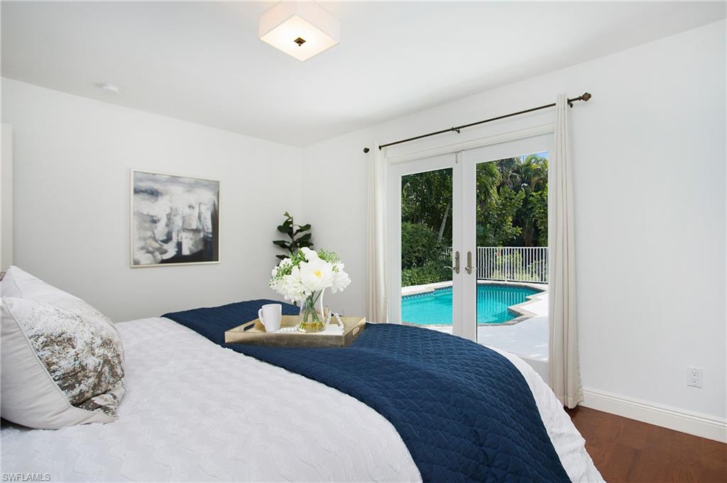 1534 Northgate Drive Naples, FL 34105 - Photo 17 of 50 a bedroom with a bed and a large window