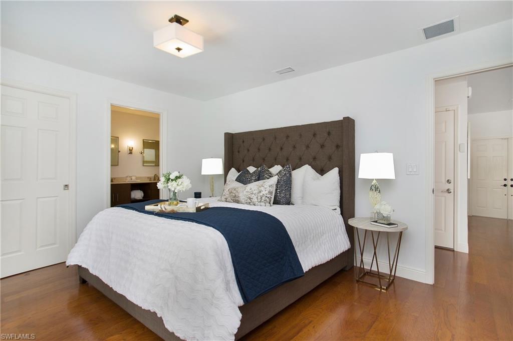 1534 Northgate Drive Naples, FL 34105 - Photo 18 of 50 a bedroom with a bed and wooden floor