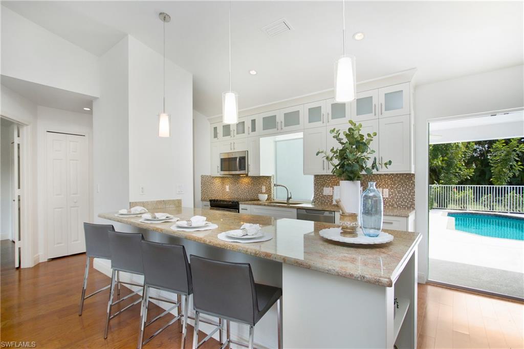 1534 Northgate Drive Naples, FL 34105 - Photo 2 of 50 a kitchen with a table and chairs in it