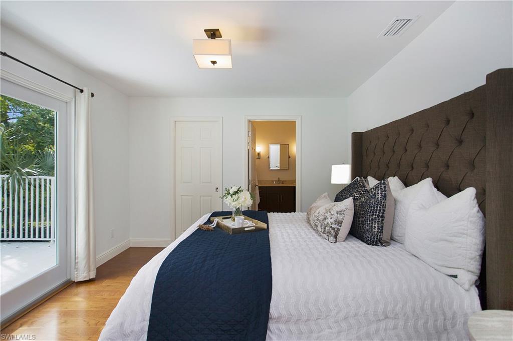 1534 Northgate Drive Naples, FL 34105 - Photo 21 of 50 a bedroom with a bed and lamp