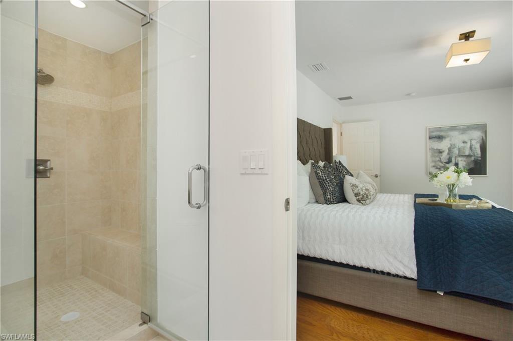 1534 Northgate Drive Naples, FL 34105 - Photo 23 of 50 a bedroom with a bed and a flat tv screen on dresser