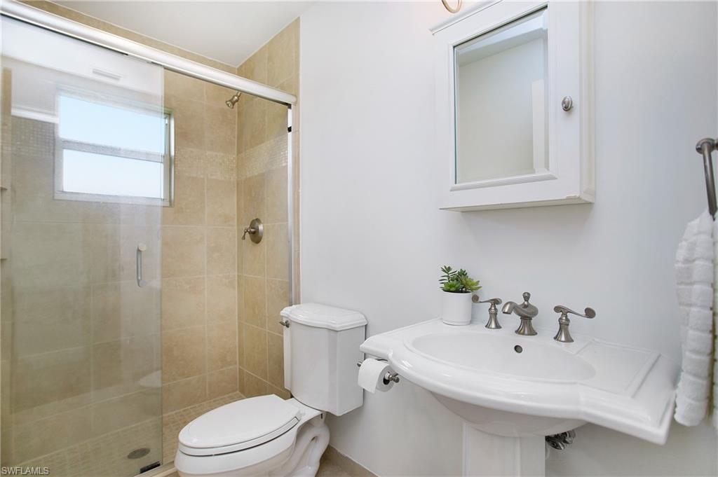 1534 Northgate Drive Naples, FL 34105 - Photo 26 of 50 a bathroom with a sink a toilet and shower
