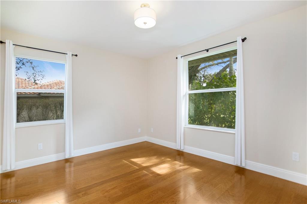 1534 Northgate Drive Naples, FL 34105 - Photo 27 of 50 a view of a bedroom with wooden floor and a window