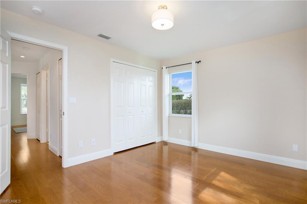 1534 Northgate Drive Naples, FL 34105 - Photo 28 of 50 a view of an empty room with wooden floor and a window
