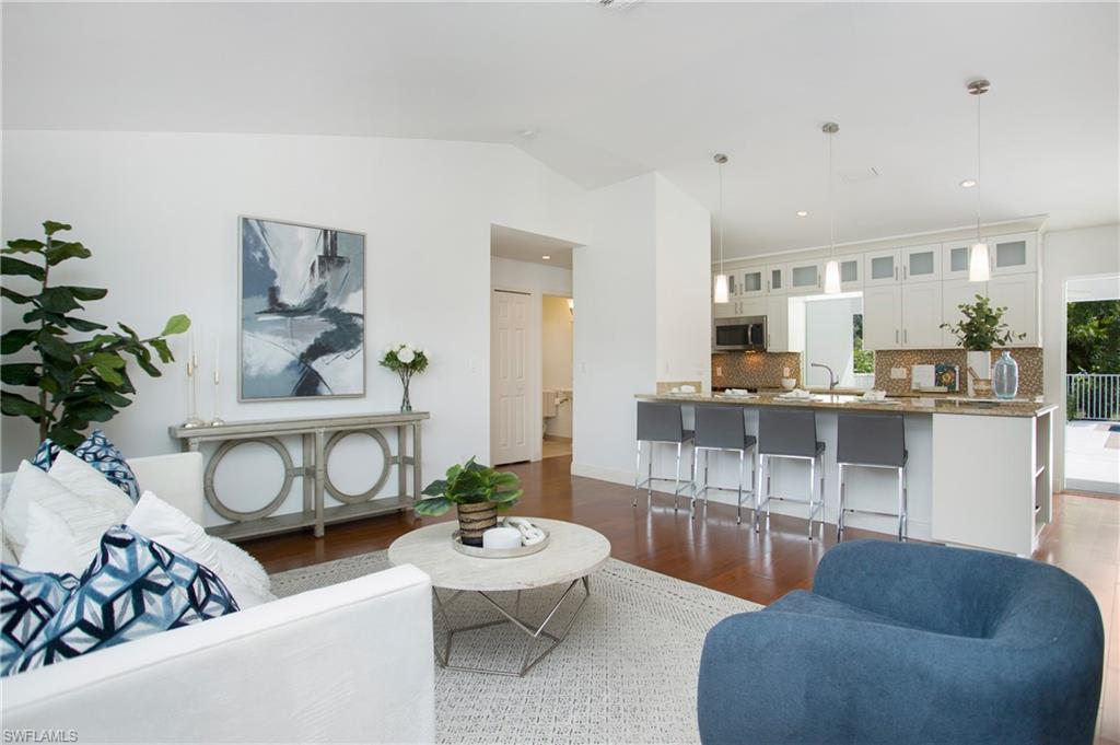 1534 Northgate Drive Naples, FL 34105 - Photo 3 of 50 a living room with furniture and a dining table
