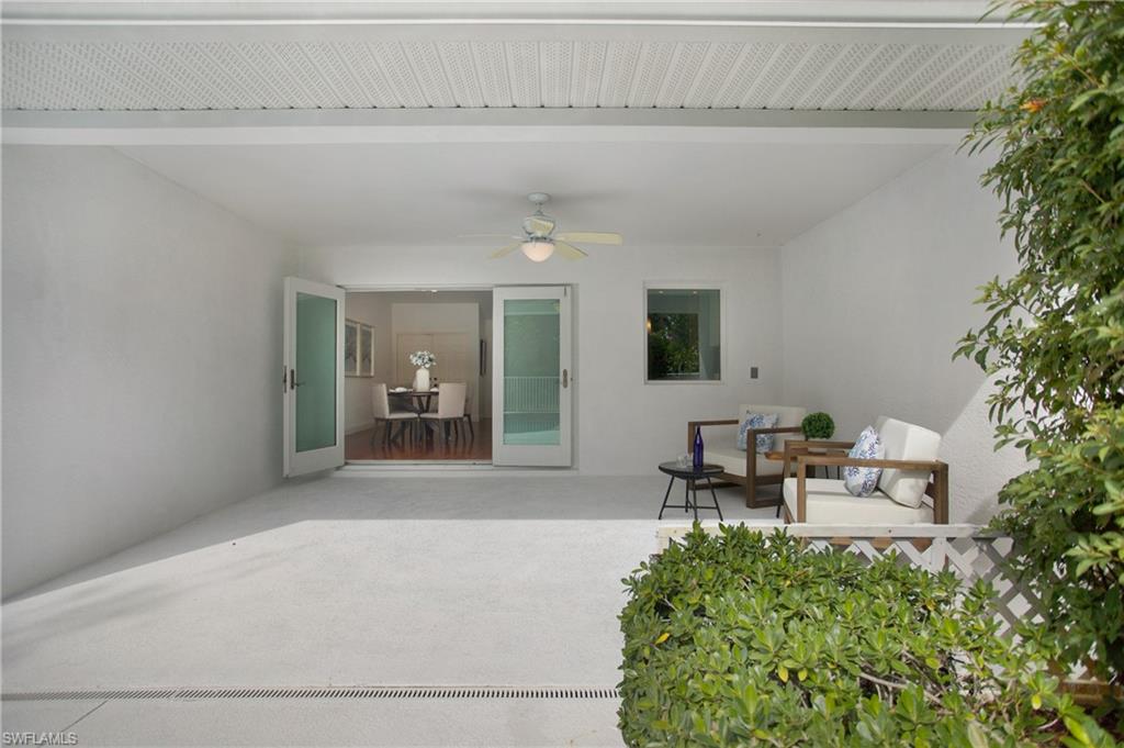 1534 Northgate Drive Naples, FL 34105 - Photo 35 of 50 a living room with furniture and a potted plant