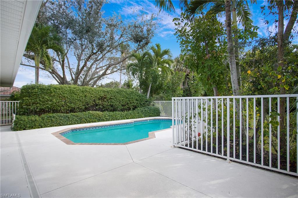 1534 Northgate Drive Naples, FL 34105 - Photo 36 of 50 a view of yard with swimming pool and trees in the background
