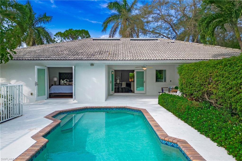 1534 Northgate Drive Naples, FL 34105 - Photo 4 of 50 a front view of a house with a yard