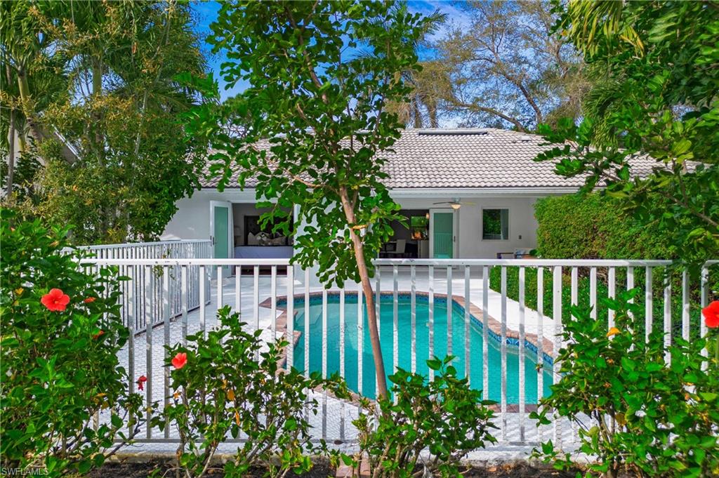 1534 Northgate Drive Naples, FL 34105 - Photo 41 of 50 a view of a house with wooden fence and a flower garden