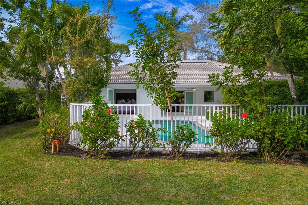 1534 Northgate Drive Naples, FL 34105 - Photo 42 of 50 a front view of a house with a yard and potted plants
