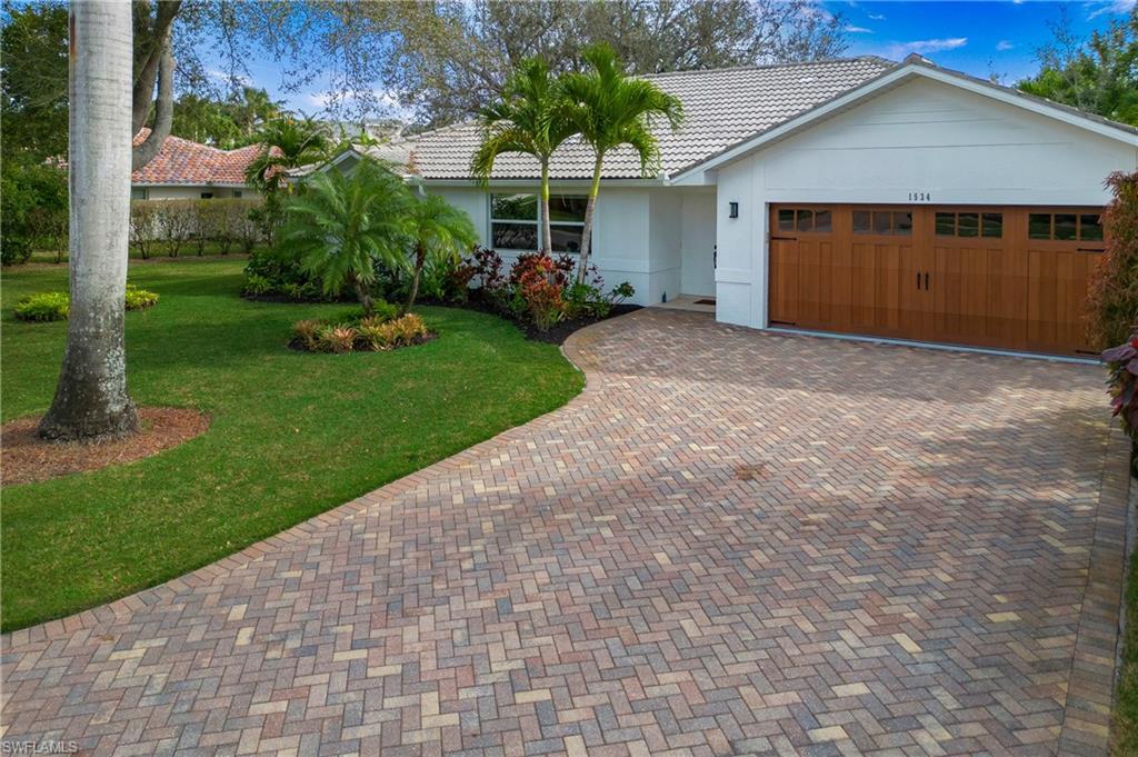 1534 Northgate Drive Naples, FL 34105 - Photo 48 of 50 a view of a house with a yard and potted plants