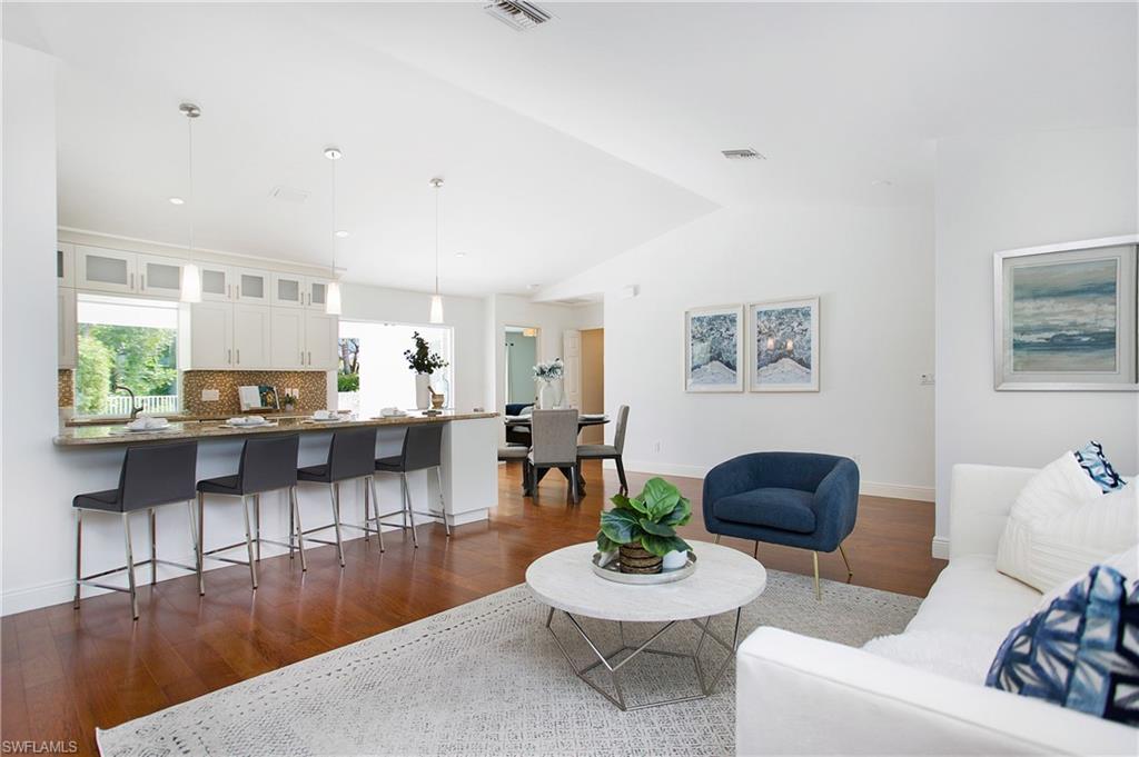 1534 Northgate Drive Naples, FL 34105 - Photo 7 of 50 a living room with furniture and a wooden floor