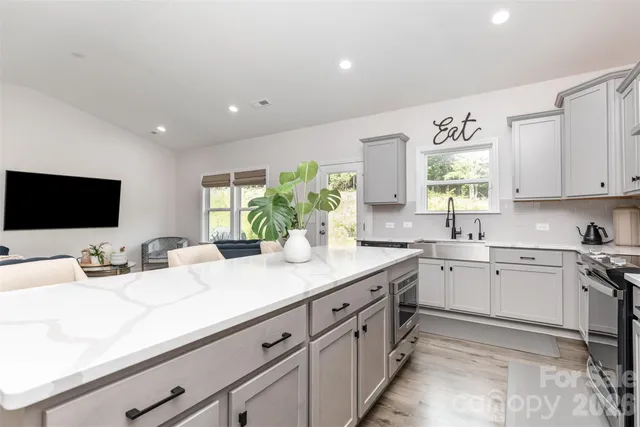 a kitchen with sink and view living room