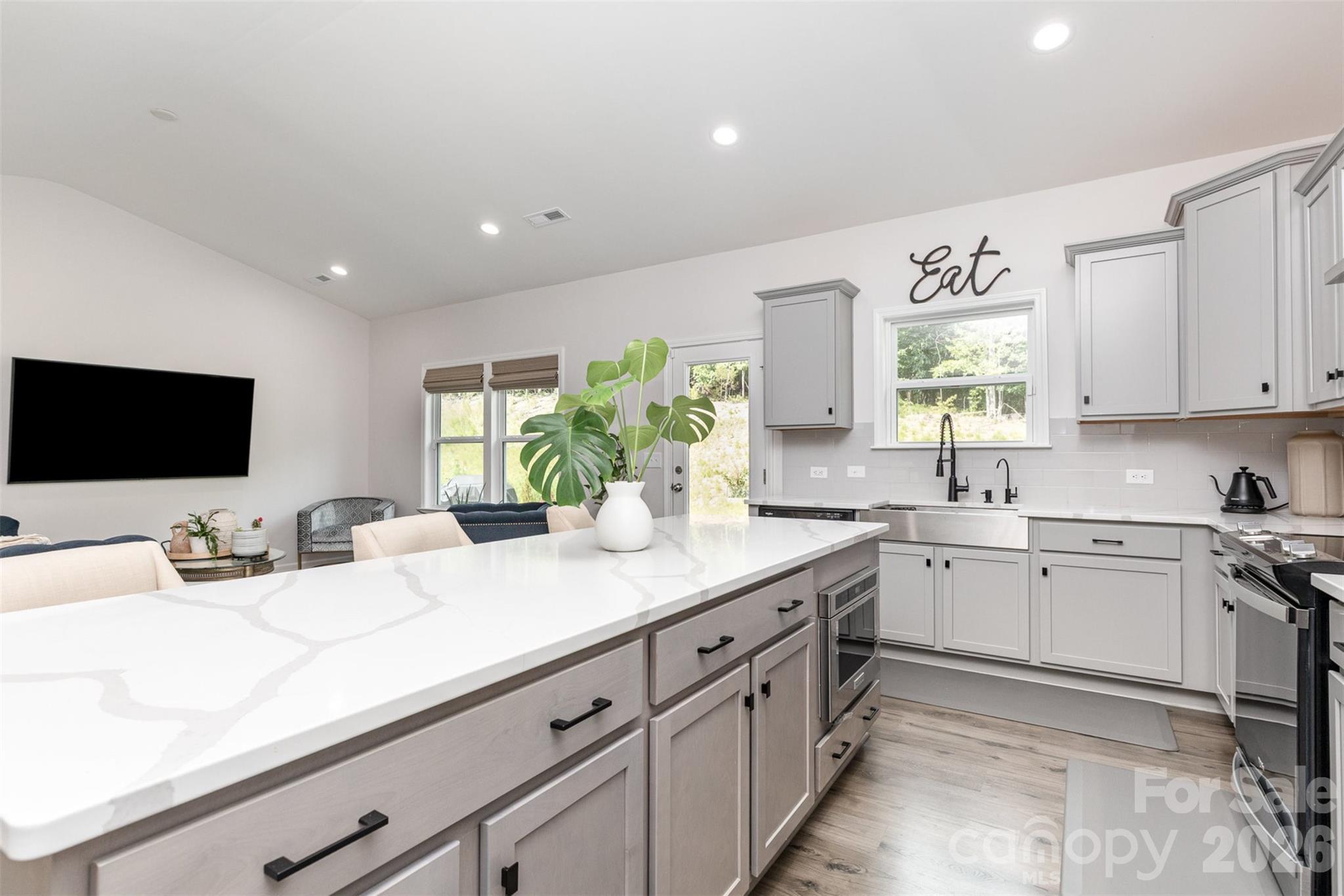 948 Scotch Meadows Loop Monroe, NC 28110 - Photo 11 of 25 a kitchen with sink and view living room