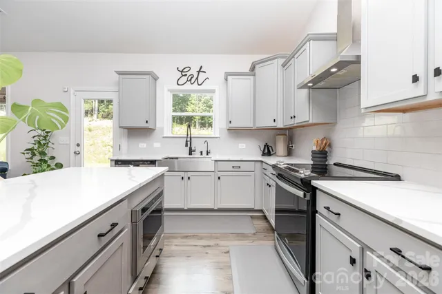 a kitchen with granite countertop white cabinets and white appliances