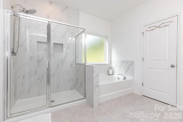 a bathroom with a bathtub and a shower