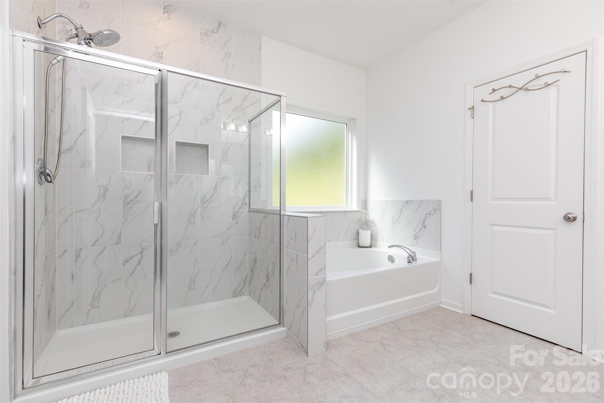 948 Scotch Meadows Loop Monroe, NC 28110 - Photo 19 of 25 a bathroom with a bathtub and a shower