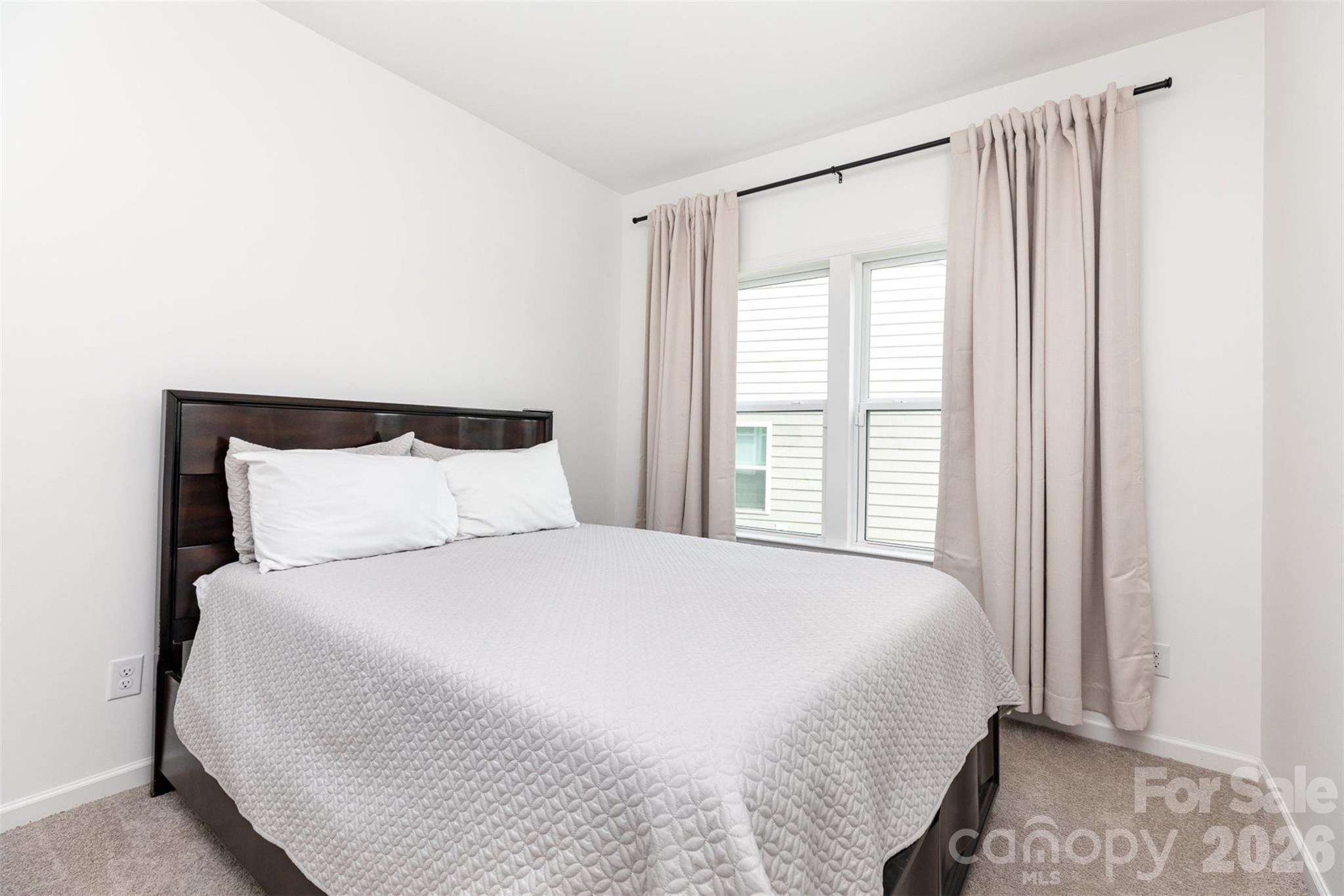 948 Scotch Meadows Loop Monroe, NC 28110 - Photo 21 of 25 a large bed sitting in a bedroom next to a window